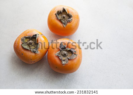 Fresh ripe persimmon on Japanese paper background