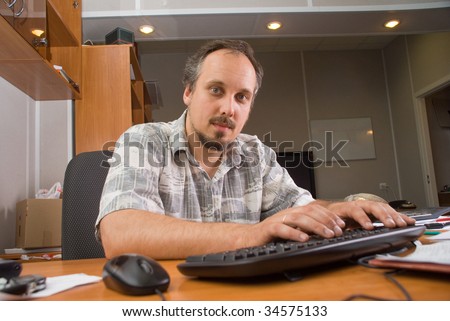 The man with computer (in a office)