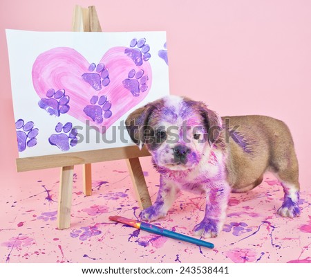 Silly puppy that made a mess painting a picture of a heart with paw prints going through it.