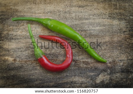 Chili Peppers / Chili peppers isolated on wood texture