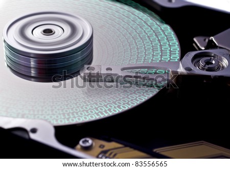 hard disk drive in close up with data on disk. head in motion