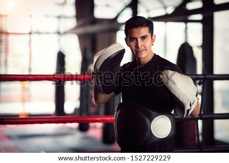 Asian kickboxing trainer in boxing gym, this photo can use for muy thai, thai, sport, fitness, coach and muay concept Foto stock © 