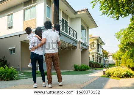 Beautiful family portrait smiling outside their new house with sunset, this photo canuse for family, father, mother and home concept Foto stock © 