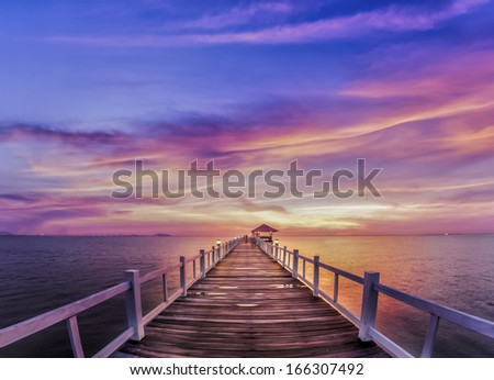 Wooded bridge in the port between sunrise.