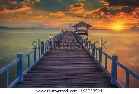 Wooded bridge in the port between sunrise at pattaya beach Thailand.