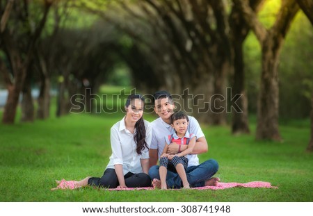 Asian family, Happy asian mother, father and daughter relax in the park