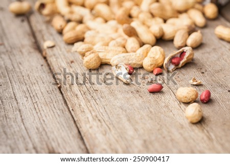 Peanuts in shells on wood background. Also available in vertical format.
