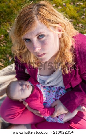 Young mother is having some nice time with her baby on a sunny day