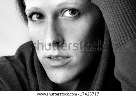 Studio portrait of a cute and beautifull girl in a turtle neck sweater paying attention