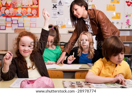 Group of little students with different ages in a classroom