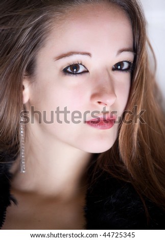 Portrait of a brunette looking at you as if she is expecting you to talk