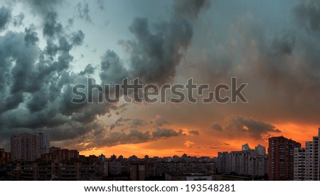 Stormy sunset sky. Twilight panoramic cityscape. Aerial view. Typical modern residential area.