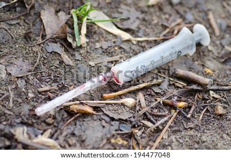 Using a syringe drug addict on the street during the day.