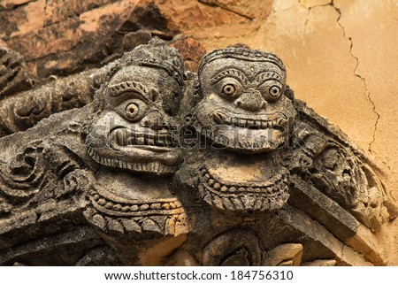 statue of two faces(full face) on the corner of ancient temple in Bagan(Pagan), Myanmar(Burma)