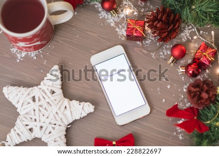 mobile phone written new years resolution on with xmas decoration
