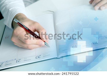 doctor writing at note book