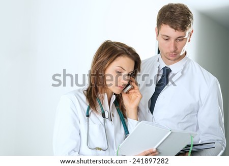 two doctors consulting on telephone at the clinic