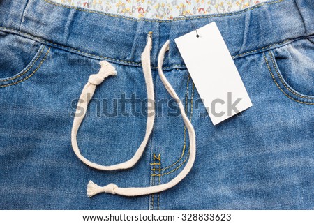 Close up of fashion blue jeans and lable tag