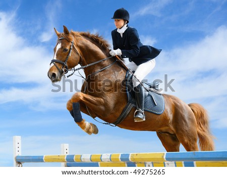 Young girl jumping with sorrel horse