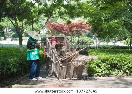 Sanitation worker is playing his mobile phone