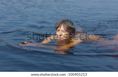 the swimming woman in the sunny summer day