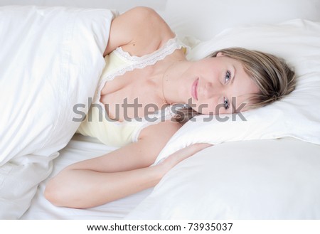 The woken up girl in the morning on a bed