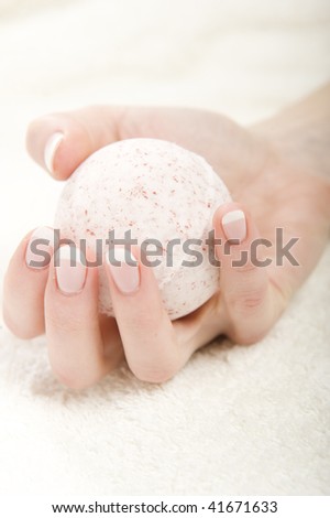 Beautiful hands with healthy skin and perfect french manicure holding sphereobject soap