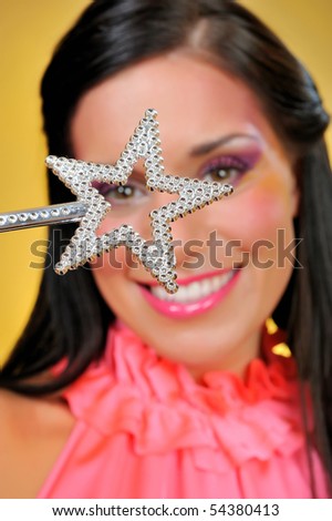 Beautiful woman with the star making a wish. focus on star