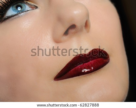 Fall fashion makeup trend. pretty woman face with bright make-up and purple lipstick