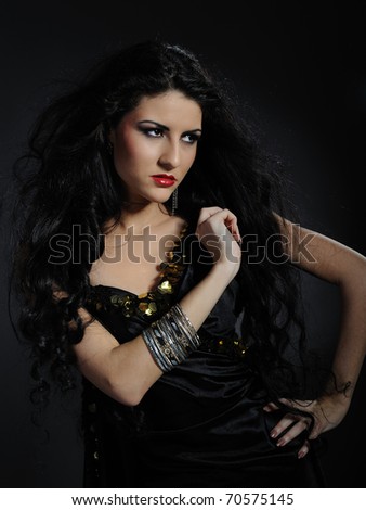 Beautiful woman with long black healthy hair in arabic traditional clothes