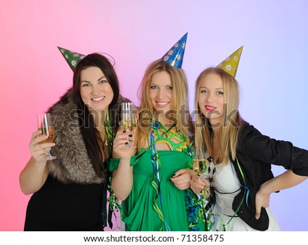 three beautiful woman with glasses of champagne celebrating on party. isolated on white background