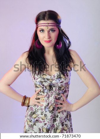 Young beautiful fashion woman with creative eye make-up and flower band in the hair