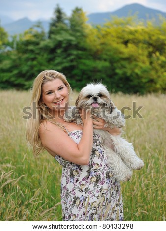 Beautiful female with cute little dog friend outdoors