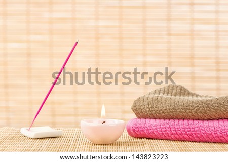 Candle with two towels and aromatic stick
