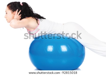 Pretty woman stretching on the blue ball, isolated on white