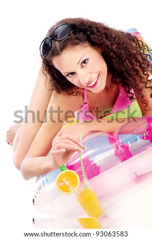 Smiled curl woman on air mattress drinking juice on white background