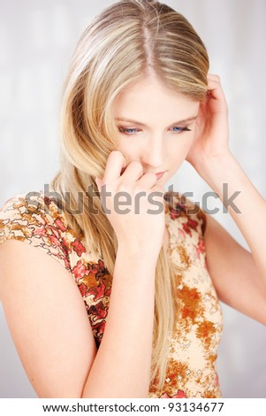 Portrait of a pretty blond woman looking down