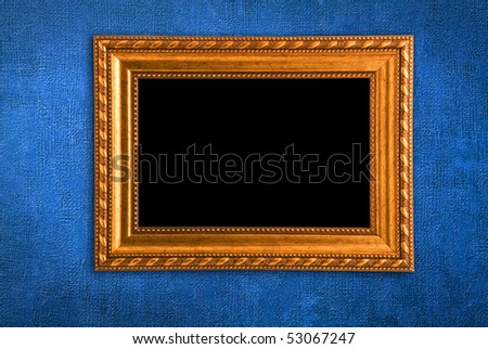 Gold frame on a old blue wall background