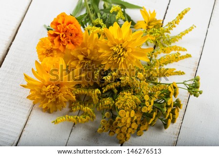 Postcard with fresh yellow flowers in bucket. Autumn theme. Thanksgiving theme.