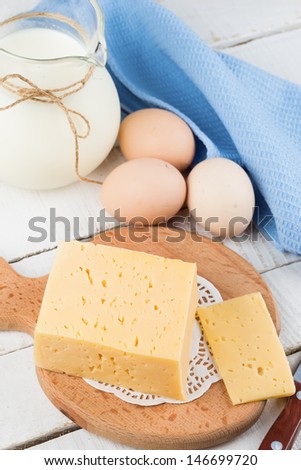 Fresh dairy products - cheese, milk, eggs. Rustic style. Bio/organic/natural ingredients. Healthy eating.