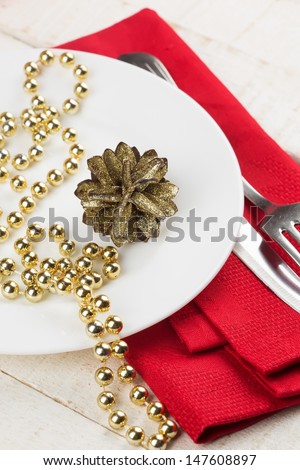 Christmas table setting. Red and gold. Selective focus.