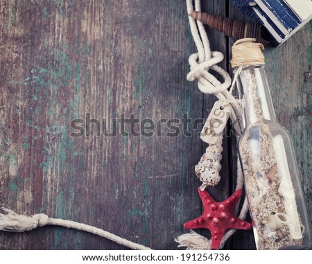 Marine items on wooden background. Sea objects on aged wooden planks. Selective focus. Top view.