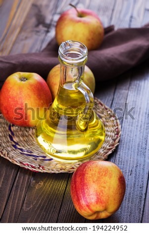 Apple vinegar and apples on  wooden table. Selective focus, vertical.