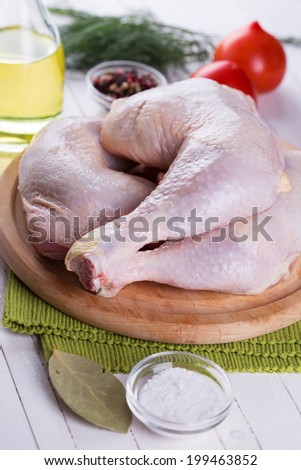 Fresh chicken meat on wooden board on table. Selective focus, vertical