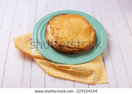 Appetizing pancakes on plate  on white table. Healthy breakfast. Selective focus.