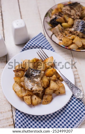 Sea fish  with potato baked in oven. Selective focus.