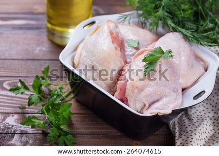 Raw chicken meat in bowl  on dark table. Selective focus. Rustic style.