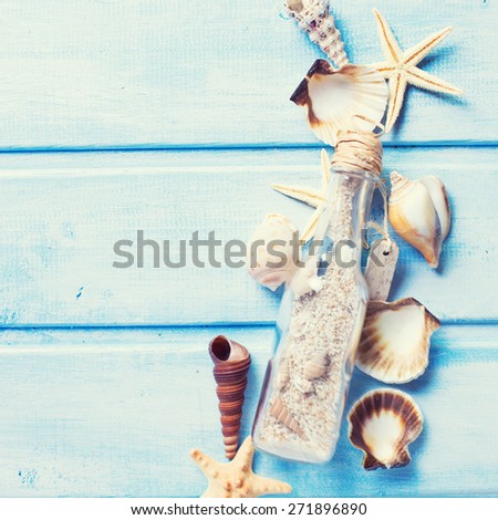 Marine items on blue painted wooden background. Sea objects on wooden planks. Selective focus. Square image.