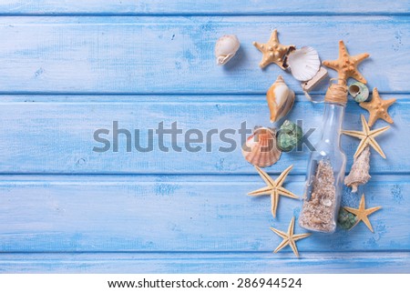 Different marine items on  blue painted wooden background. Sea objects on wooden planks. Selective focus. Place for text.