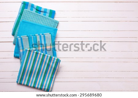 Colorful  blue kitchen towels  on white wooden background. Selective focus. Place for text.